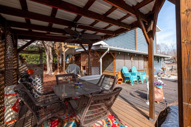 wooden terrace featuring a grill and ceiling fan