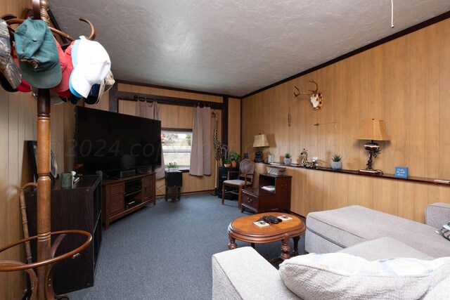 carpeted living room featuring wood walls, a textured ceiling, and ornamental molding