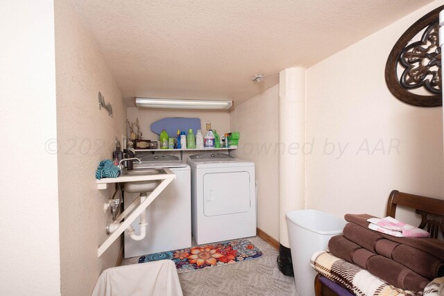 laundry room with washing machine and dryer, a textured ceiling, and carpet floors