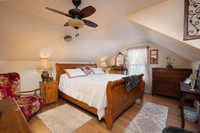 bedroom with lofted ceiling, ceiling fan, and light hardwood / wood-style flooring