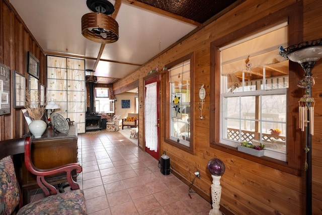 interior space with wood walls and light tile patterned floors