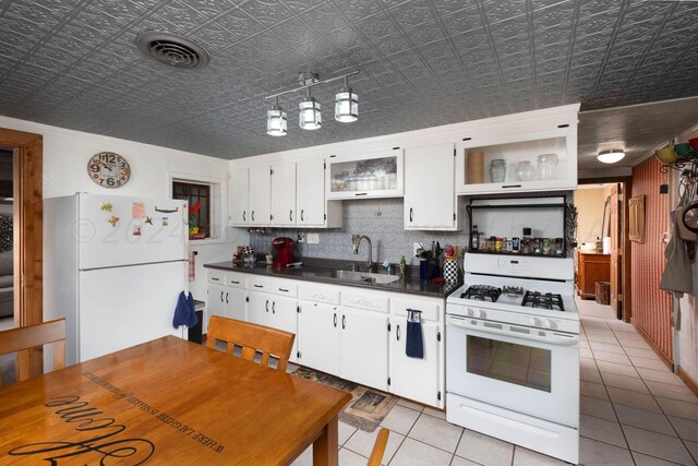 kitchen with white cabinetry, sink, white appliances, and crown molding