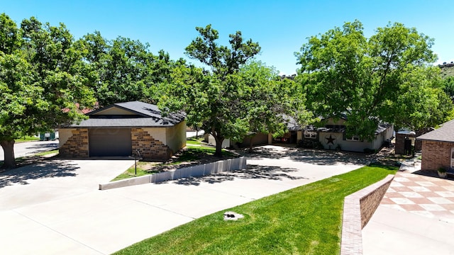 120 Port O Call Dr, Amarillo, TX 79118 - obstructed view of property featuring concrete driveway, an attached garage, brick siding, and solar panels