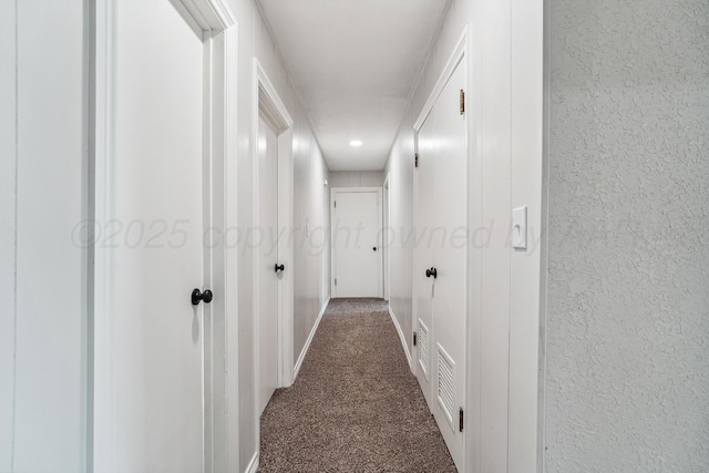 517 Whittier St, Hereford, TX 79045 - hallway featuring dark colored carpet and a textured wall