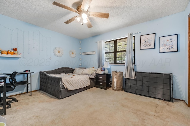 carpeted bedroom with a textured ceiling, a ceiling fan, and baseboards