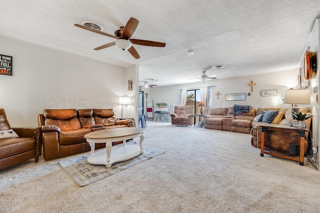 carpeted living area featuring ceiling fan, a textured ceiling, and visible vents