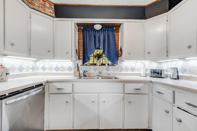 kitchen featuring dishwasher, white cabinets, and a sink