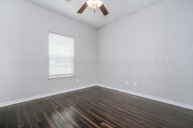 unfurnished room featuring baseboards, a ceiling fan, and dark wood finished floors