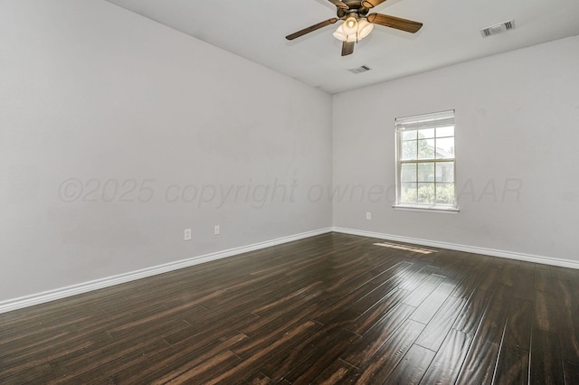 empty room featuring baseboards, ceiling fan, dark wood-style flooring, and visible vents