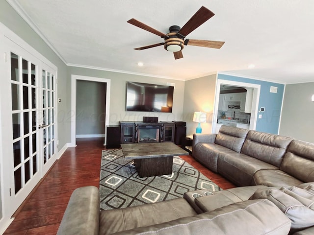 living room with ceiling fan, dark wood-type flooring, and ornamental molding