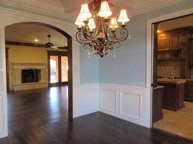 unfurnished dining area featuring ceiling fan, dark hardwood / wood-style floors, and crown molding