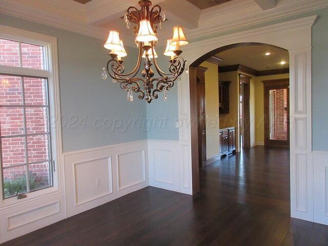 interior space with ceiling fan, dark hardwood / wood-style flooring, and ornamental molding