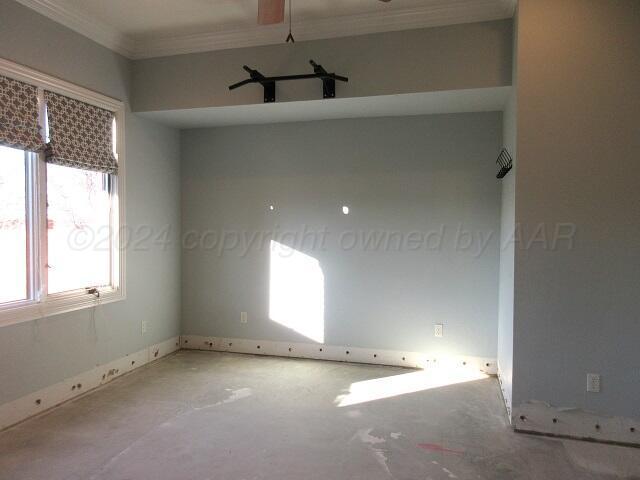 spare room featuring a chandelier and crown molding