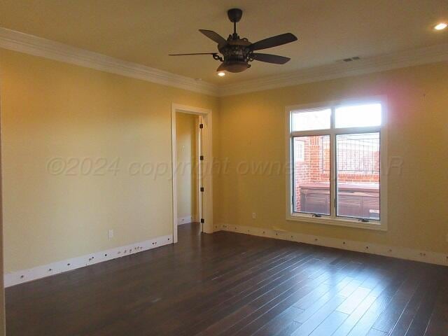 empty room with crown molding, ceiling fan, and dark hardwood / wood-style flooring