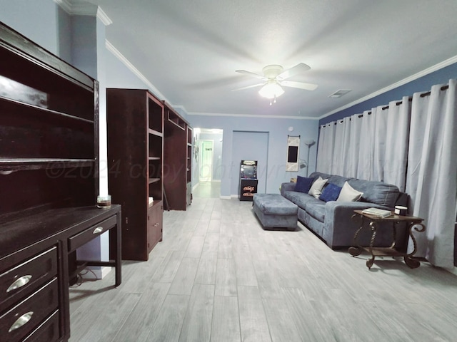 living room featuring ceiling fan, ornamental molding, and light wood-type flooring