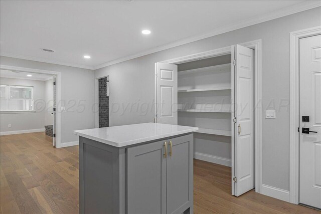 4400 Gem Lake Rd, Amarillo, TX 79106 - kitchen featuring gray cabinets, wood finished floors, ornamental molding, light countertops, and a kitchen island