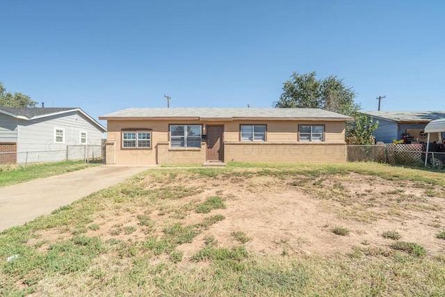 ranch-style house with fence and brick siding