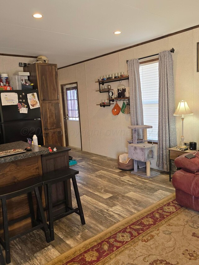 interior space featuring wood-type flooring and ornamental molding