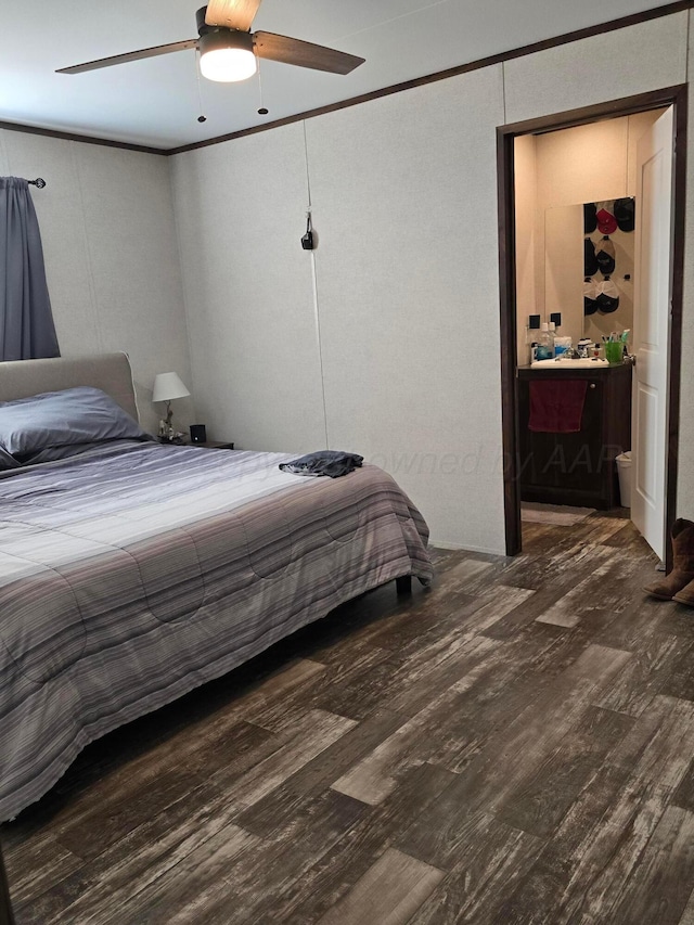 bedroom featuring ornamental molding, dark hardwood / wood-style floors, ceiling fan, and ensuite bath