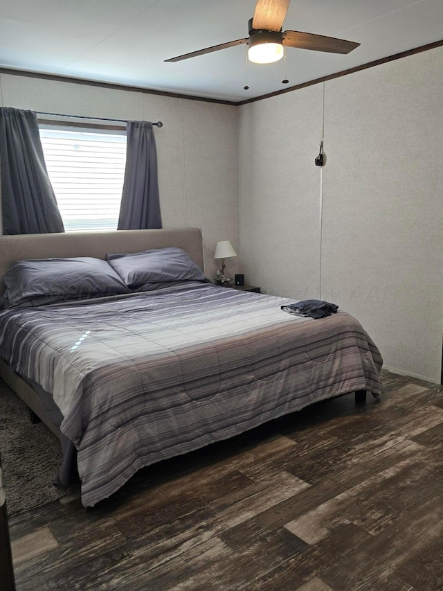 bedroom featuring wood-type flooring, ornamental molding, and ceiling fan