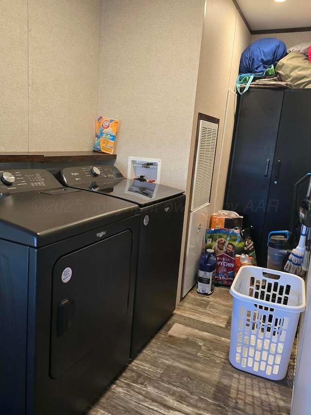 washroom with washing machine and dryer and wood-type flooring