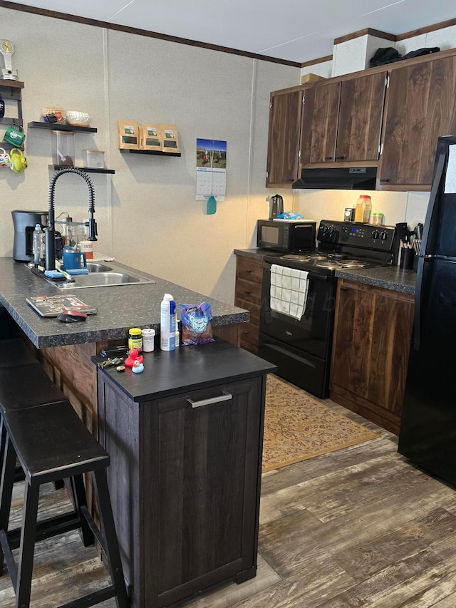 kitchen featuring dark wood-type flooring, sink, crown molding, dark brown cabinets, and black appliances