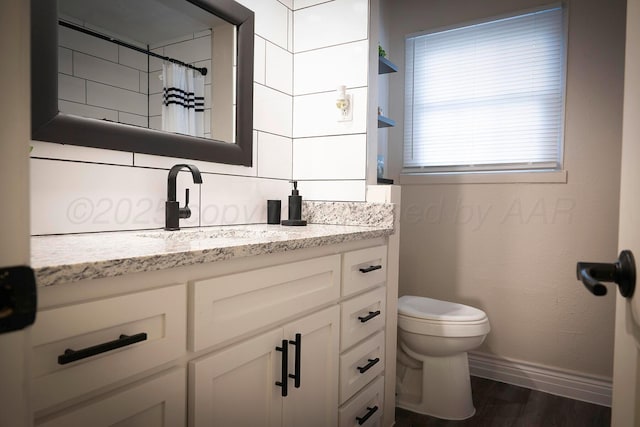 bathroom with toilet, a shower with curtain, wood-type flooring, vanity, and backsplash