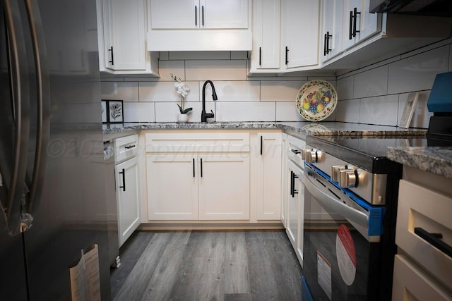 kitchen featuring stainless steel appliances, exhaust hood, and white cabinets