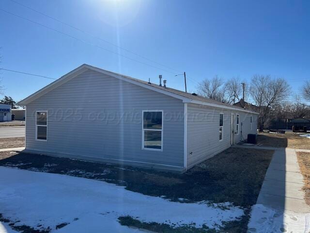 view of snow covered exterior featuring central AC