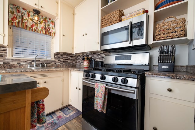 kitchen with stainless steel appliances, backsplash, open shelves, and dark wood-type flooring