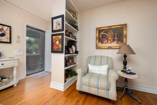 living area featuring light wood-style floors and baseboards