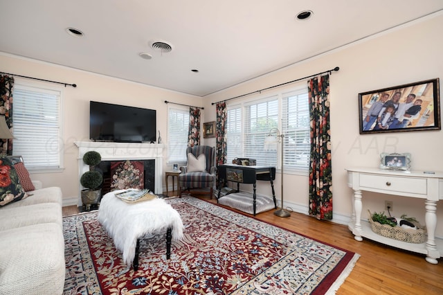 living room with wood finished floors, a high end fireplace, baseboards, and recessed lighting