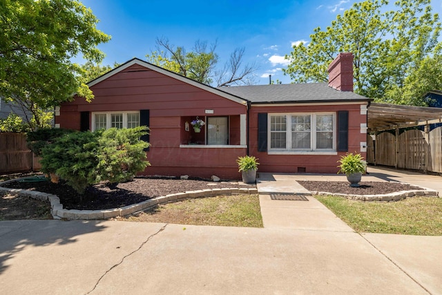 ranch-style home featuring a chimney, a carport, crawl space, and concrete driveway