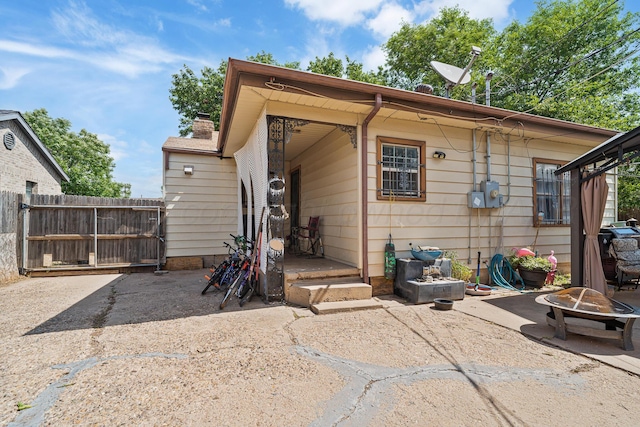 3616 NE 21st Ave, Amarillo, TX 79107 - back of property with a fire pit, a patio, and a chimney