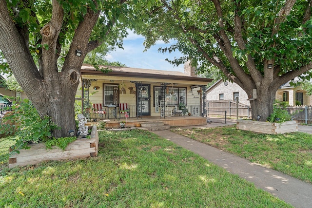3616 NE 21st Ave, Amarillo, TX 79107 - view of front of home with a vegetable garden, a chimney, and covered porch