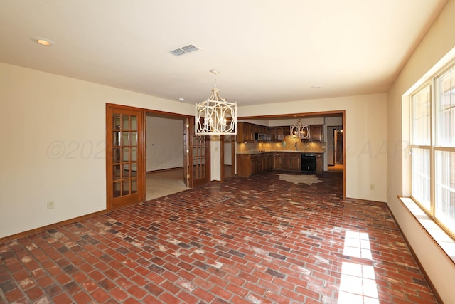 4410 Chandler Dr, Amarillo, TX 79109 - unfurnished living room featuring brick floors, a chandelier, baseboards, recessed lighting, and a sink