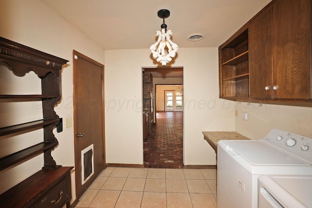 4410 Chandler Dr, Amarillo, TX 79109 - washroom featuring cabinet space, washing machine and clothes dryer, light tile patterned floors, and baseboards