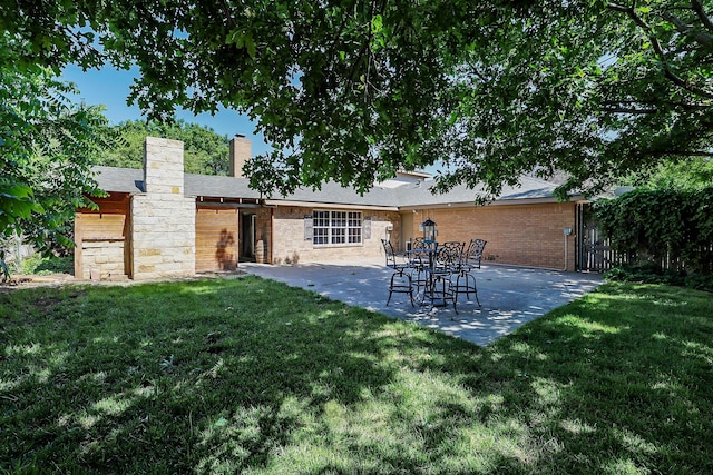 4410 Chandler Dr, Amarillo, TX 79109 - rear view of property featuring a patio, a chimney, and brick siding