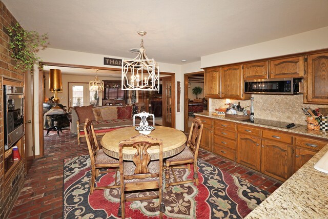 4410 Chandler Dr, Amarillo, TX 79109 - dining room with brick floors and a chandelier