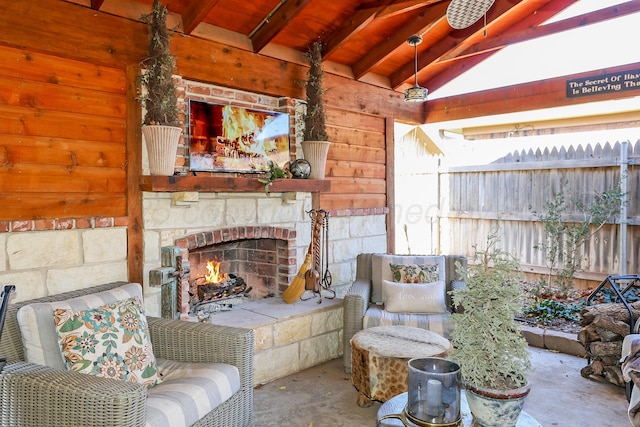 4410 Chandler Dr, Amarillo, TX 79109 - living room with unfinished concrete floors, an outdoor stone fireplace, and wood walls