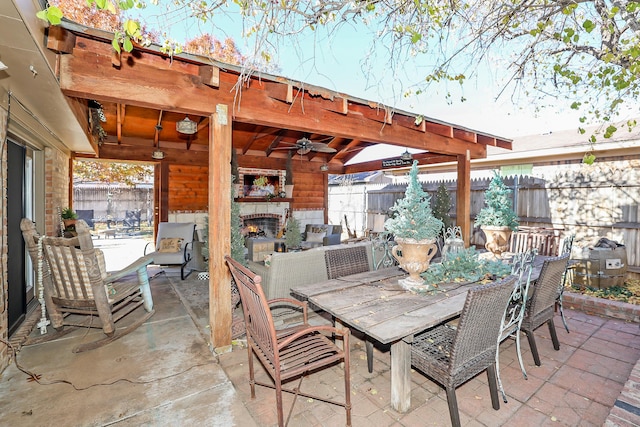 4410 Chandler Dr, Amarillo, TX 79109 - view of patio / terrace featuring a warm lit fireplace, ceiling fan, and outdoor dining space