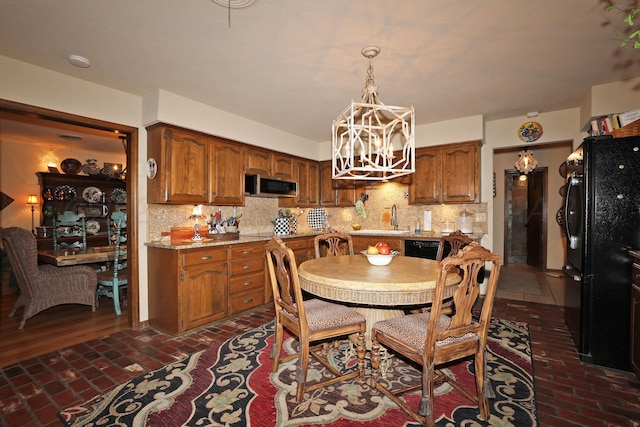 4410 Chandler Dr, Amarillo, TX 79109 - dining room featuring brick flooring and a chandelier