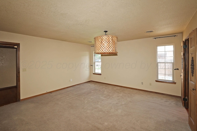 4410 Chandler Dr, Amarillo, TX 79109 - spare room featuring carpet flooring, plenty of natural light, a textured ceiling, and baseboards