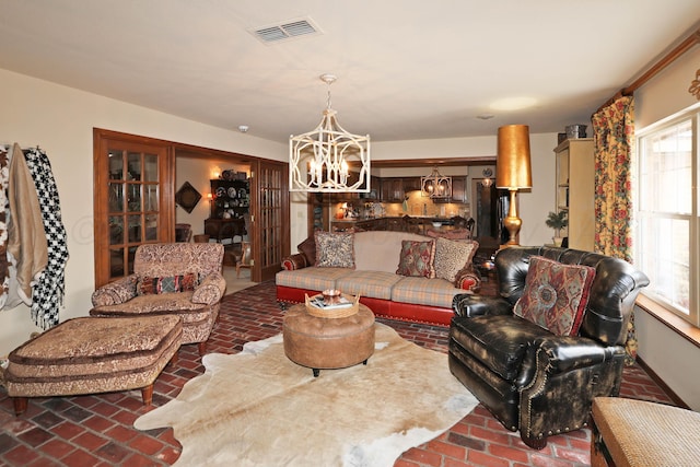 4410 Chandler Dr, Amarillo, TX 79109 - living area with brick floors, a chandelier, and healthy amount of natural light