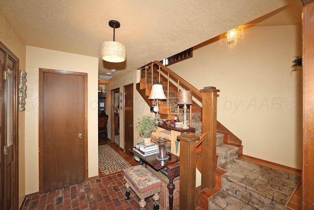 4410 Chandler Dr, Amarillo, TX 79109 - foyer entrance featuring stairway, a textured ceiling, and brick floors