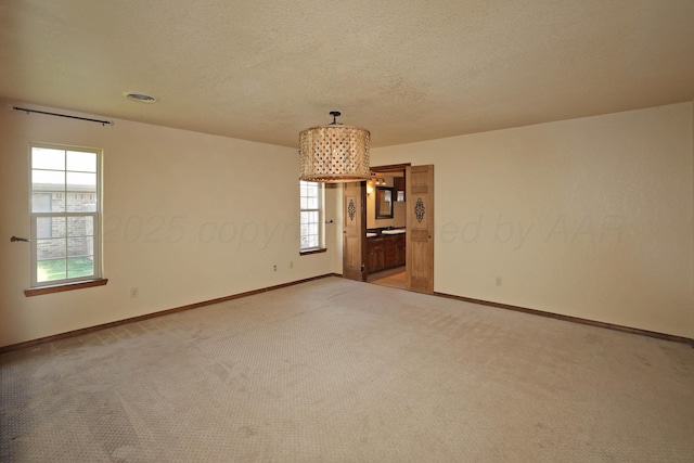 4410 Chandler Dr, Amarillo, TX 79109 - empty room with light carpet, baseboards, and a textured ceiling