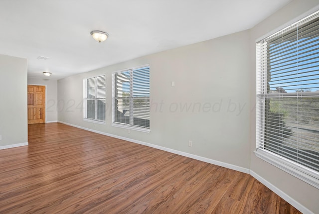 13701 Cedarwood Dr, Amarillo, TX 79118 - empty room with wood finished floors, plenty of natural light, and baseboards