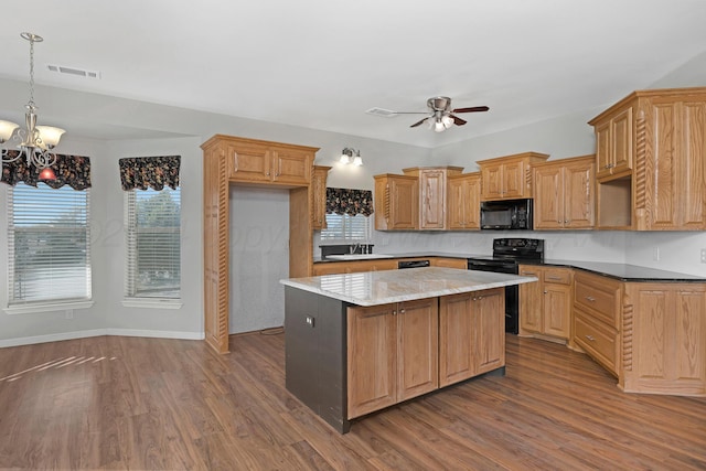 13701 Cedarwood Dr, Amarillo, TX 79118 - kitchen featuring black appliances, a chandelier, a kitchen island, a ceiling fan, and a sink