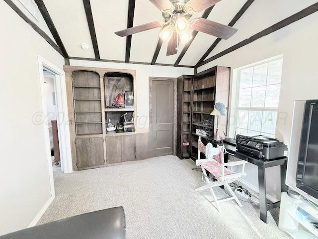 carpeted office space featuring lofted ceiling with beams and ceiling fan