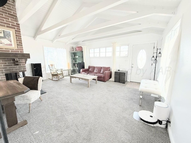 living room featuring carpet flooring, lofted ceiling with beams, and a brick fireplace